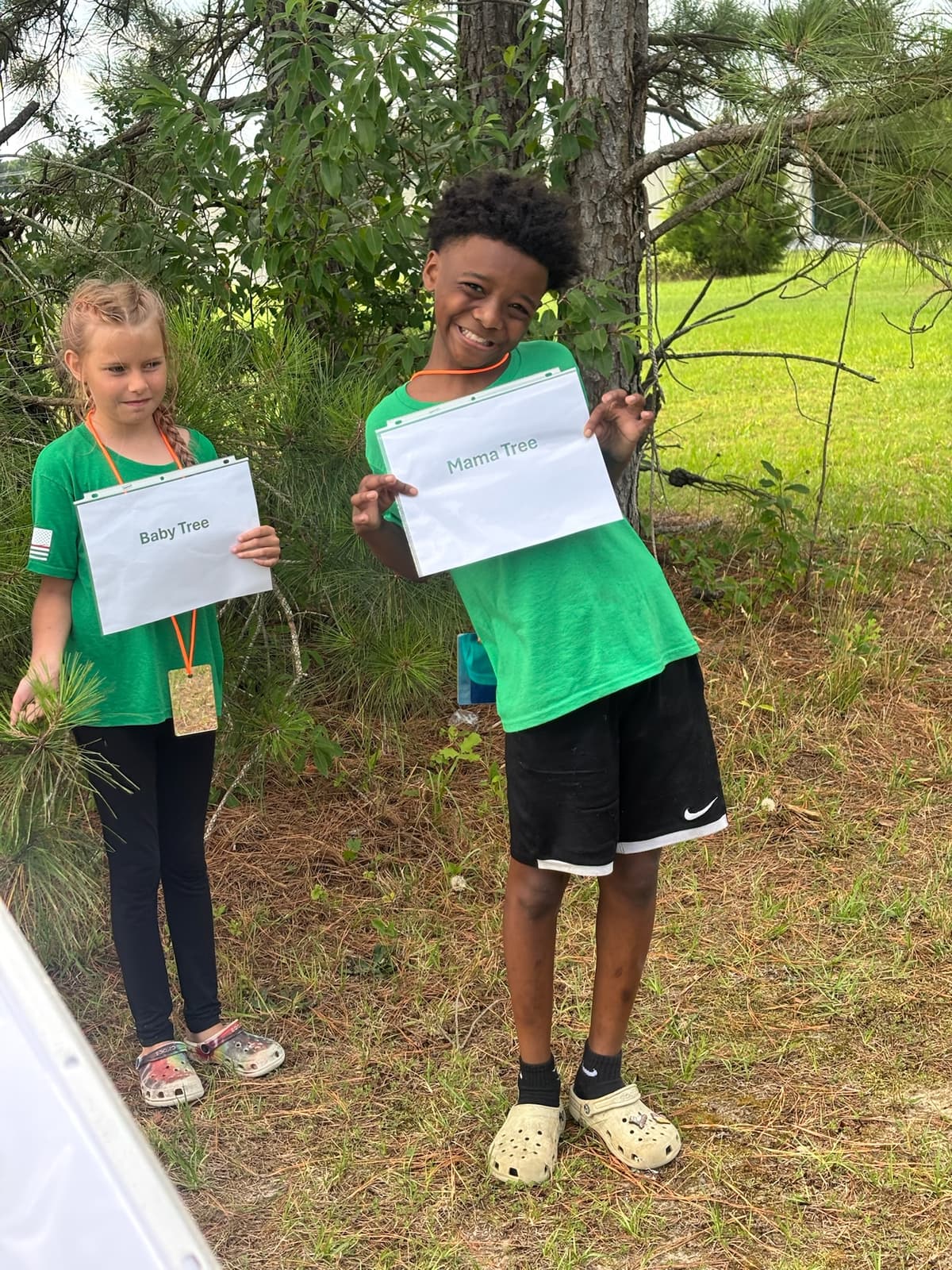 Two campers practice Hug-a-Tree outdoor survival